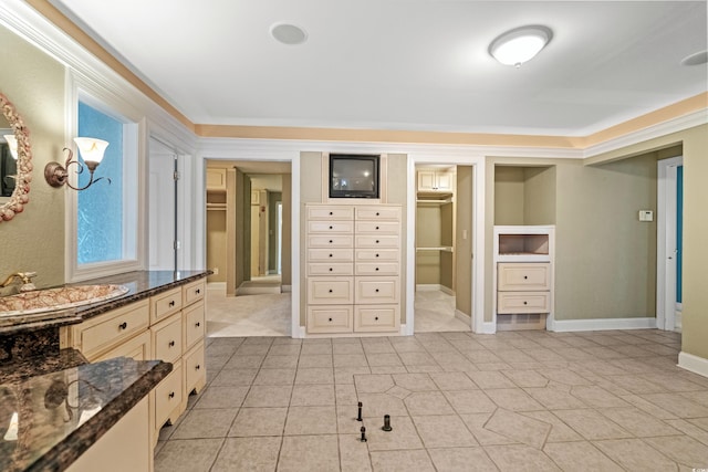 8000 Beach Dr, Myrtle Beach, SC 29572 - bedroom featuring light tile patterned flooring, baseboards, a sink, and ensuite bath