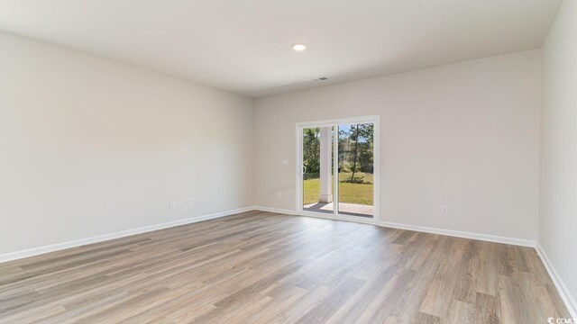 spare room featuring light hardwood / wood-style floors