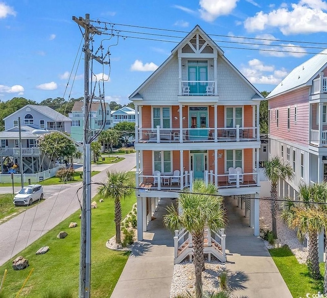 view of front of property with a balcony and a front yard