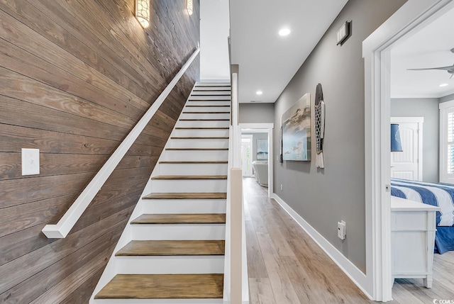 staircase featuring ceiling fan, light hardwood / wood-style flooring, and plenty of natural light