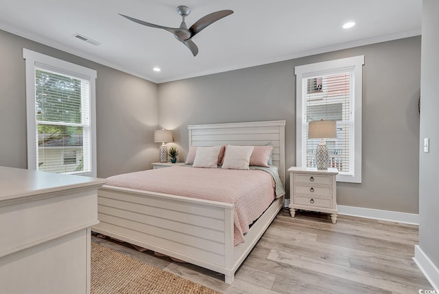 bedroom featuring ceiling fan, light hardwood / wood-style flooring, and ornamental molding