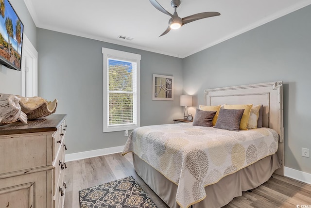 bedroom with ceiling fan, light hardwood / wood-style flooring, and ornamental molding