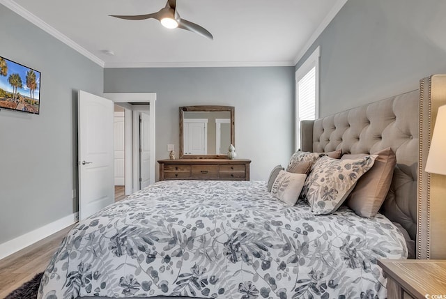 bedroom with ornamental molding, ceiling fan, and hardwood / wood-style floors