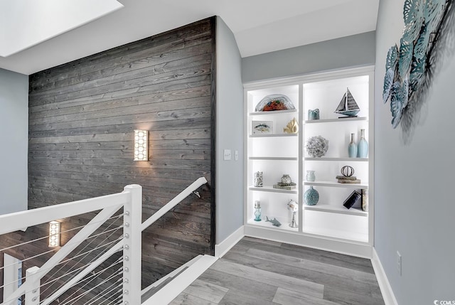 hall featuring wooden walls and wood-type flooring