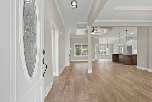 foyer entrance featuring crown molding, ceiling fan, baseboards, beam ceiling, and light wood-style floors