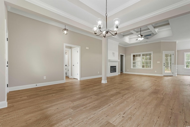 unfurnished living room featuring light wood-type flooring, a ceiling fan, coffered ceiling, a fireplace, and crown molding