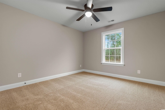 spare room with visible vents, baseboards, carpet, and a ceiling fan