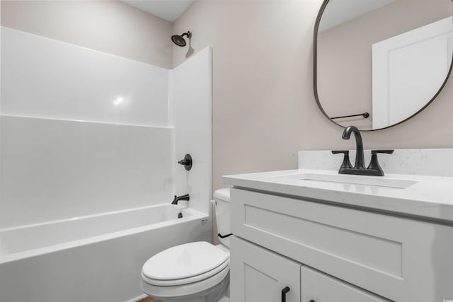 bathroom with tub / shower combination, toilet, and vanity