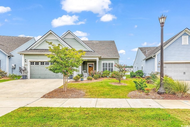 view of front of house featuring a garage and a front lawn