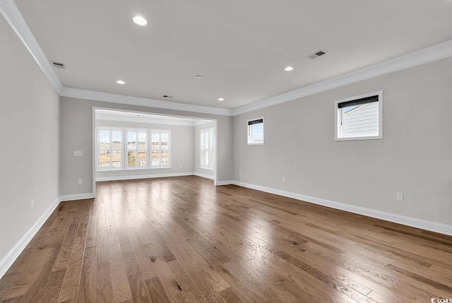 spare room featuring hardwood / wood-style flooring and crown molding