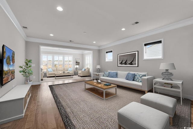 living room featuring hardwood / wood-style floors and crown molding