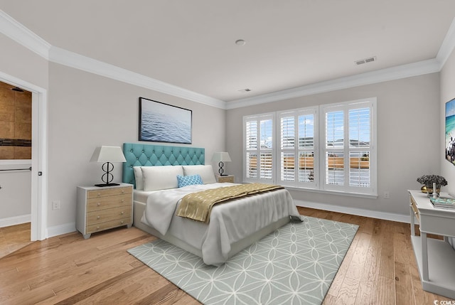 bedroom with light hardwood / wood-style floors and ornamental molding