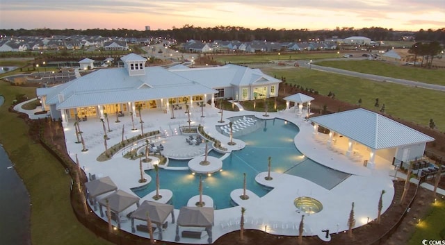 view of pool at dusk