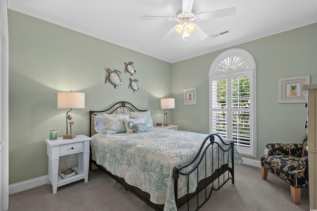 carpeted bedroom with crown molding and ceiling fan