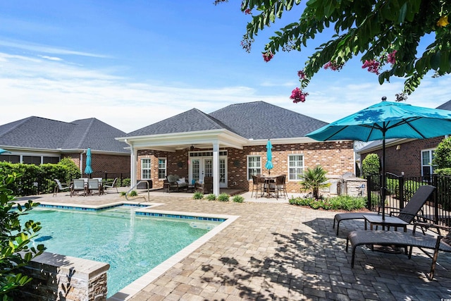 view of swimming pool with a patio and ceiling fan