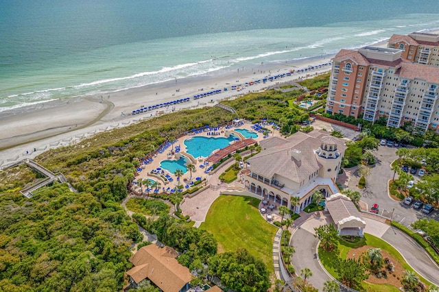 birds eye view of property with a beach view and a water view