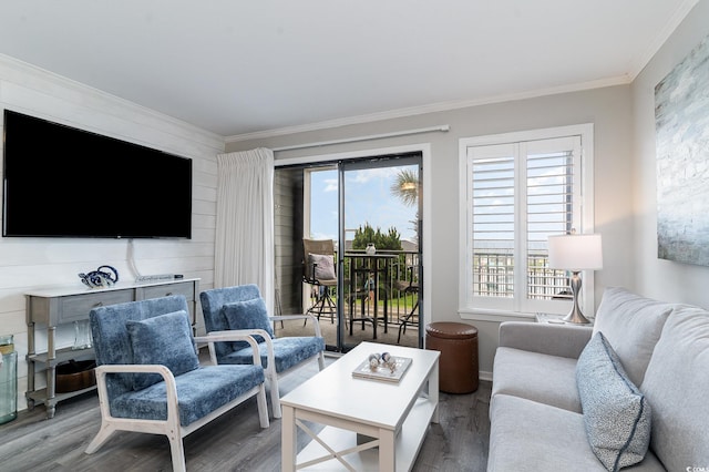 living room with ornamental molding, hardwood / wood-style flooring, and plenty of natural light