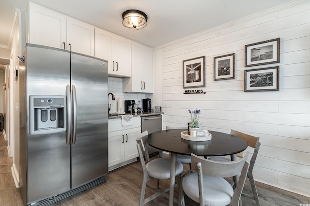 kitchen featuring backsplash, sink, white cabinetry, appliances with stainless steel finishes, and dark hardwood / wood-style flooring