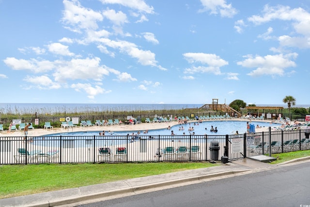 view of swimming pool with a water view