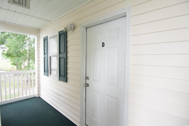 doorway to property with covered porch