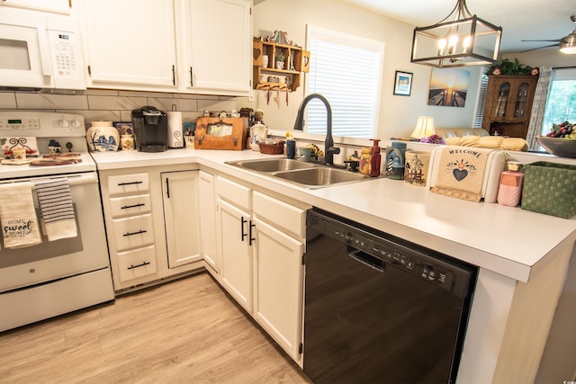 kitchen with white cabinetry, white appliances, ceiling fan with notable chandelier, light hardwood / wood-style floors, and decorative backsplash