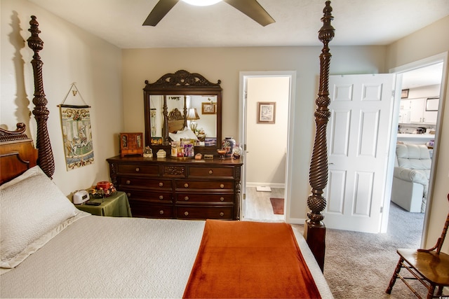 carpeted bedroom with ensuite bath and ceiling fan