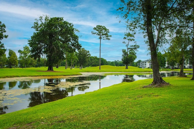 surrounding community featuring a water view and a lawn