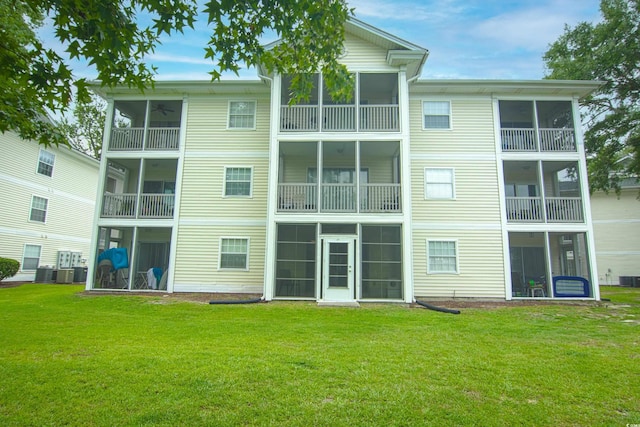 back of house featuring a lawn and central AC unit