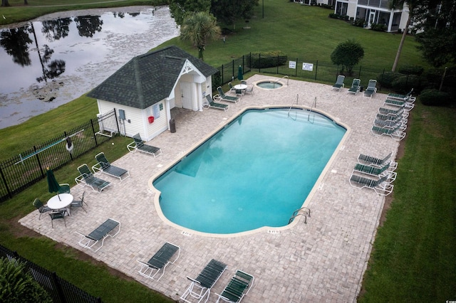 community pool with a yard, an outbuilding, fence, and a patio