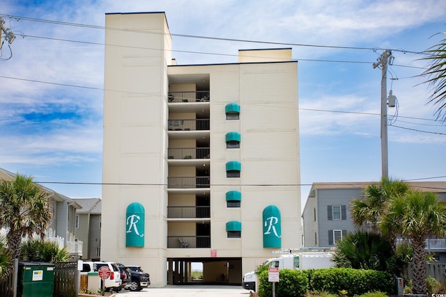 view of building exterior featuring uncovered parking