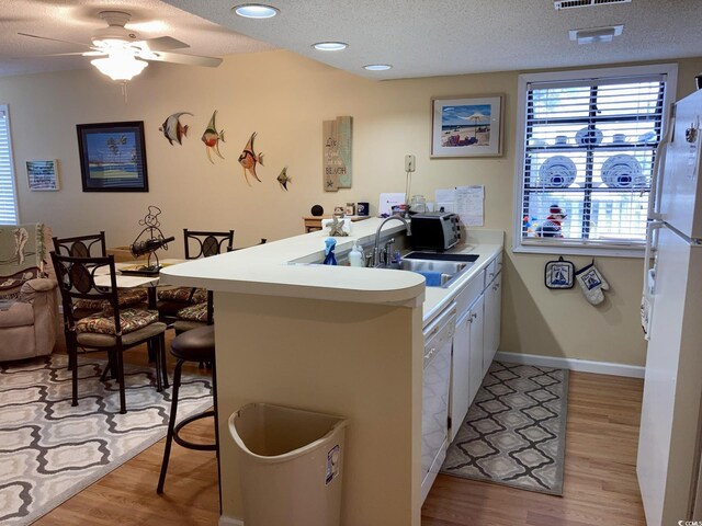 351 Lake Arrowhead Rd Unit 20-179, Myrtle Beach, SC 29572 - kitchen featuring a textured ceiling, a sink, a peninsula, and white appliances