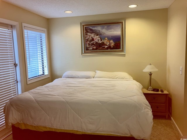 bedroom with carpet and a textured ceiling