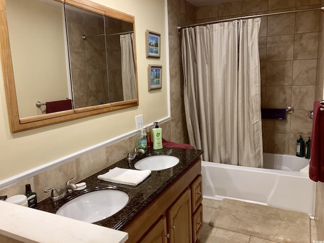 bathroom featuring vanity, shower / bath combo with shower curtain, and tile patterned flooring