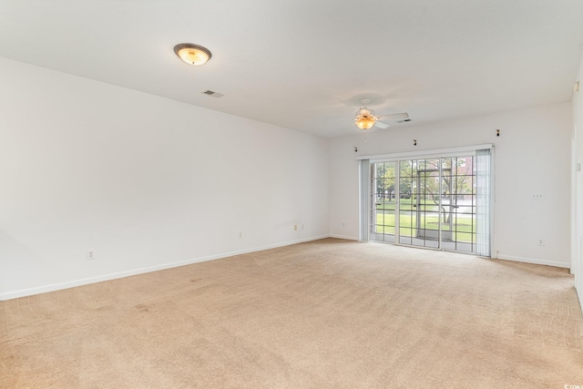 carpeted empty room featuring ceiling fan