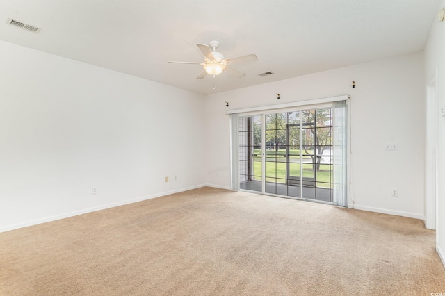 carpeted spare room with ceiling fan