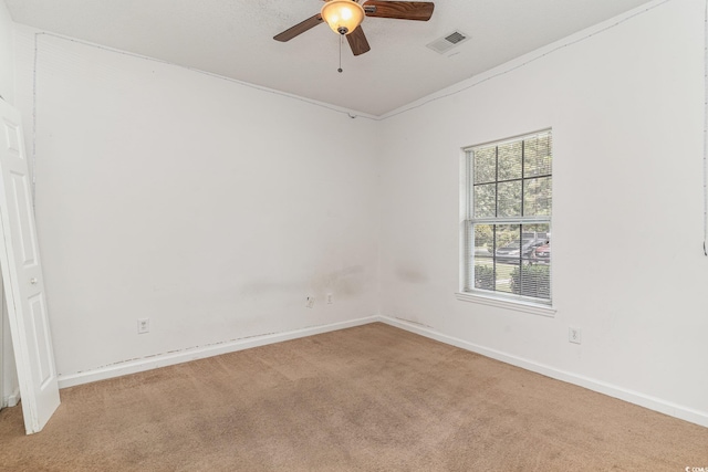 empty room featuring ceiling fan and light colored carpet