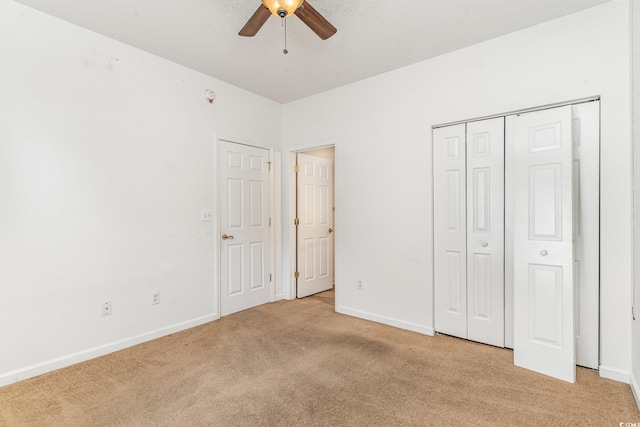 unfurnished bedroom with light carpet and ceiling fan