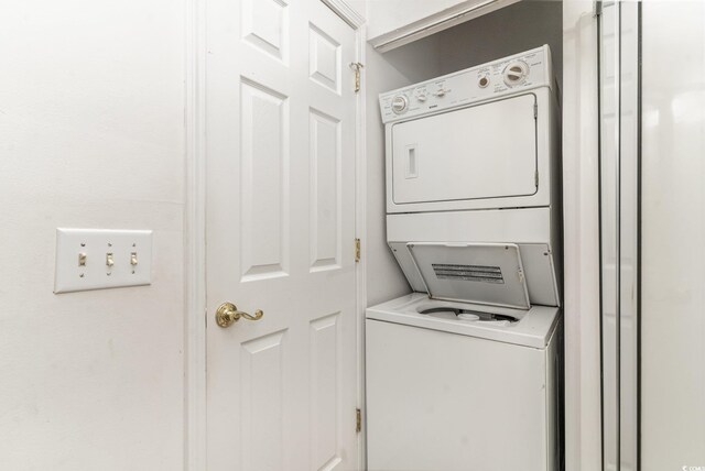 clothes washing area with stacked washer / drying machine