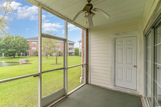 unfurnished sunroom with ceiling fan and plenty of natural light