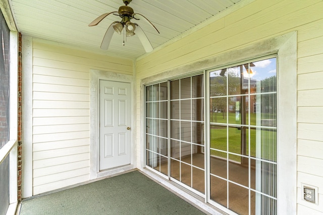 unfurnished sunroom featuring ceiling fan