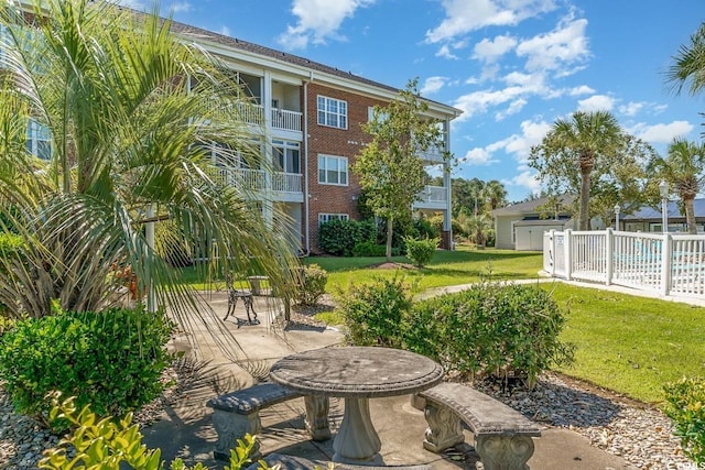 view of home's community featuring a patio and a yard