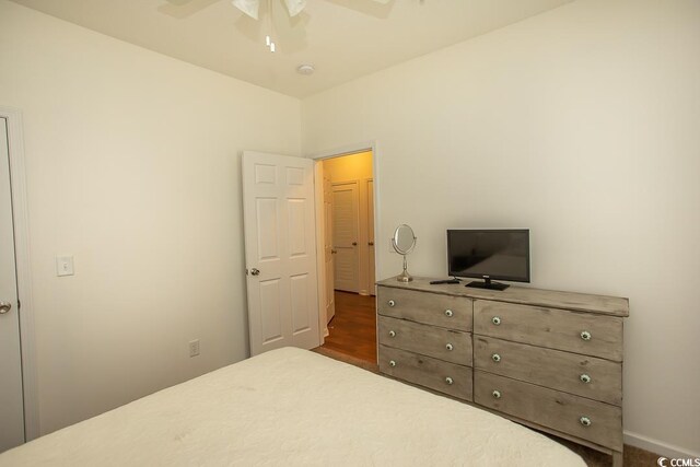 bedroom featuring ceiling fan and dark hardwood / wood-style flooring