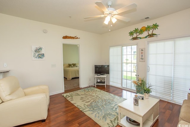 living room with ceiling fan and dark hardwood / wood-style floors