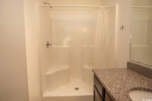 bathroom featuring vanity and walk in shower