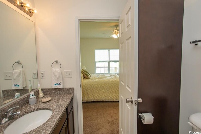 bathroom featuring ceiling fan, toilet, and vanity