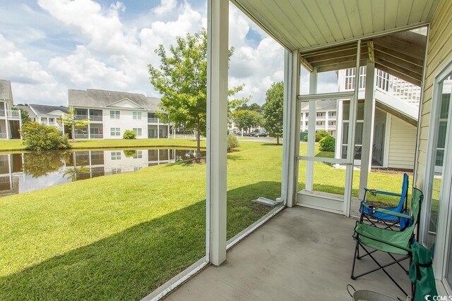 unfurnished sunroom featuring a water view