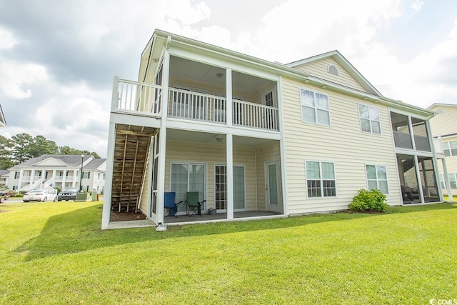 rear view of house featuring a balcony, a patio area, and a yard