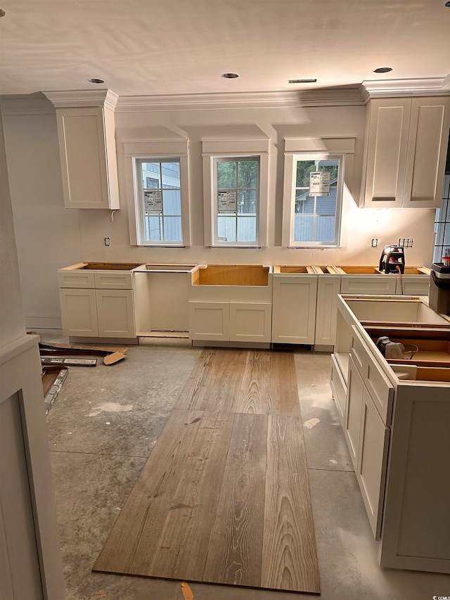 kitchen featuring ornamental molding and light wood-type flooring