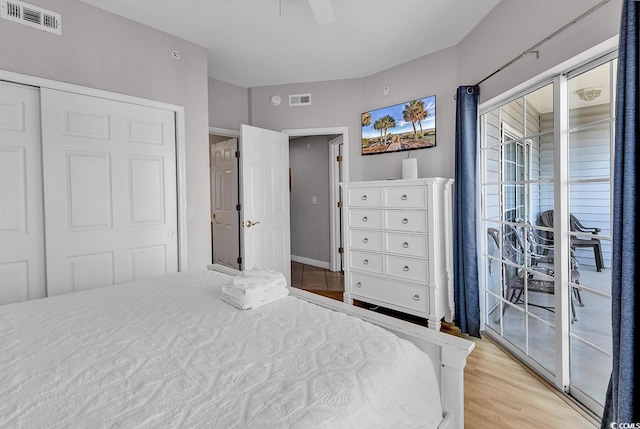 bedroom featuring light wood-style floors, visible vents, and ceiling fan