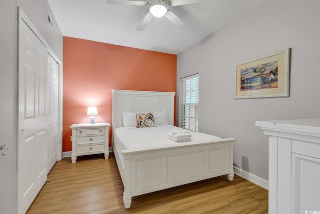 bedroom featuring visible vents, light wood-type flooring, a ceiling fan, and baseboards